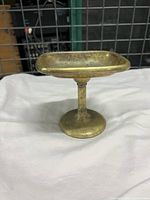 Front view of solid brass soap dish showing rectangular top and pedestal base.