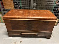 Front view of the cedar lined blanket box showing wood grain and bottom drawer with handle.