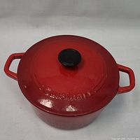 Top view of red enameled cast iron pot with lid on