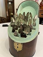 Case open showing all spoons seated in velour-lined compartments