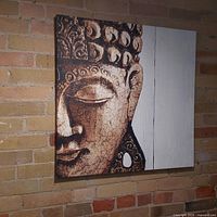 Front view of Buddha face print with detailed texture and color tones.