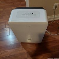 Angled front view of Danby dehumidifier on wood floor