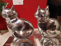 Pair of silver metal cat figurine stocking hooks, each with a jeweled collar (red and clear jewels).