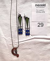 Full view of the sterling silver necklace and pierced earrings on white background with auction number 29