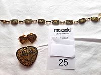 Clear image showing the entire jewelry set - bracelet, heart-shaped earrings, and triangular brooch on white background.