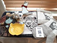 Overview of kitty-themed kitchen items including cat creamer, yellow cat spoon holder, cat trivet, kitchen mitts, and stained glass cat figure