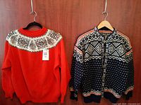 Front view of both sweaters on hangers