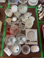 Overview of crystal bowls, shot glasses, plates, and serving dishes arranged on a table