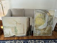 Two abstract mixed medium paintings on canvas, framed, placed against a sofa showing overall size and condition.