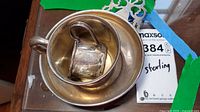 Set of sterling silver bowl and two cups with Maxsold sticker visible for scale