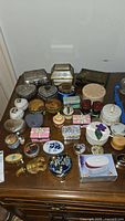 Full overview of assorted trinket boxes laid out on wooden table
