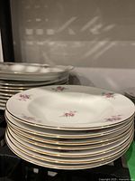 Stack of soup bowls with floral design and gold rim detail