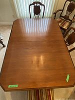 Top view of the polished wood dining table showing the rectangular surface with beveled edges.