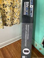 Photo showing packaging with Bin Warehouse and Proslat branding, highlighting the product is a heavy duty 8 tote rack.