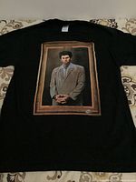 Black T-shirt with a portrait of Kramer character from Seinfeld printed on the front, centered with a frame style border.