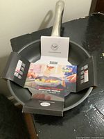 Top view of Kuhn Rikon frying pan showing packaging sleeve indicating new item