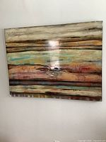 Frontal view of the large glazed abstract painting mounted on the wall, showing horizontal stripes of natural and pastel tones