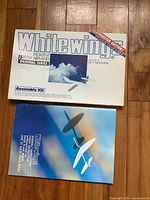 Front of the White Wings box showing 15 paper airplanes and sky background.