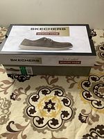 Closed Skechers shoe box with label showing shoe size and model details