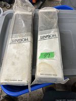 Two packages of Hobart welding rods sealed in plastic showing brand and general condition