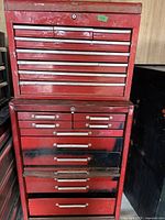 Full front view of two-piece red tool chest showing top and bottom units with drawers closed.