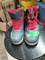 Front view of gray winter boots with red laces, showing condition and style.