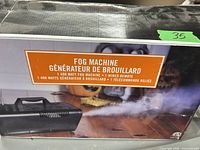 Box showing the label with product details: 1400 watt fog machine with wired remote.