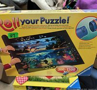 Photo of Roll Your Puzzle board box with product image and details.