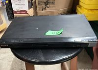 Front view of the Sony DVD player showing power button and DVD tray