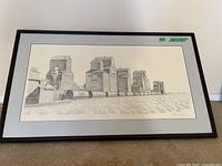Full view of framed print depicting grain silos in a rural field, showing the artwork and frame condition.