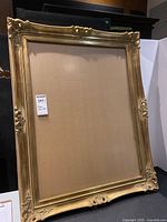 Full view of the golden ornate frame showing its decorative edges and overall dimensions.