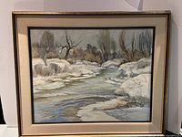 Full front view of framed painting showing winter river landscape