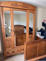 Front view showing three mirrored doors and two drawers