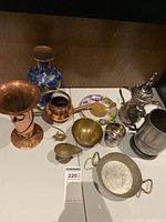 Wide view showing all metal decorative items together on a shelf
