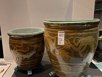 Both planters side by side showing brown glaze, dragon motif, glass tops and feet