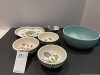 Full view of all six items: three botanical pattern Portmeirion bowls, heart-shaped dish, blue serving bowl, and butter bell with lid.