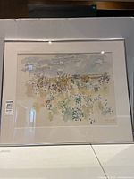 Framed watercolor painting centered on white backdrop
