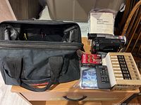 Overall view including soft case, camcorder, tapes, remote in bag and manual