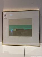 Front view of framed print showing abstract color bands, white mat and gold-tone frame