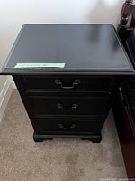 Top view of the wood nightstand showing smooth painted surface and the dimensions label on the edge.