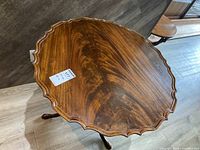 Angled view of tabletop showing scalloped edge and wood grain