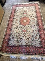 Top-down view of full area rug showing central medallion, field and borders.