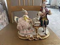 Front view of the Germany Dresden vintage figurine showing woman playing piano and man playing guitar