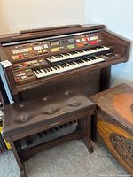 Full view of Technics Sound PCM SX-G7 electric organ with multiple control buttons, dual keyboards, pedalboard, and matching padded bench.