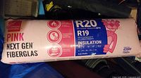 Photo showing full unopened bag of Owens Corning Pink Next Gen Fiberglas R20 insulation