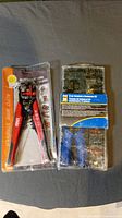 Photo showing the automatic wire stripper tool in packaging and the 57-piece terminal connector kit.