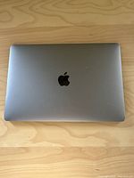 Closed view of the laptop top case showing Space Gray aluminum finish and Apple logo