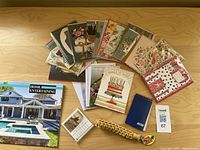 Overview of the assortment showing greeting cards, calendars, a keychain, and a small notebook on a wood surface.
