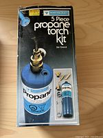 Front of the box showing Mastercraft 5 piece propane torch kit with image of a propane cylinder and accessories included.