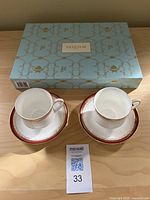 Photo of two Royal Albert Holyrood cups on matching saucers with a boxed set of Vahdam teas behind